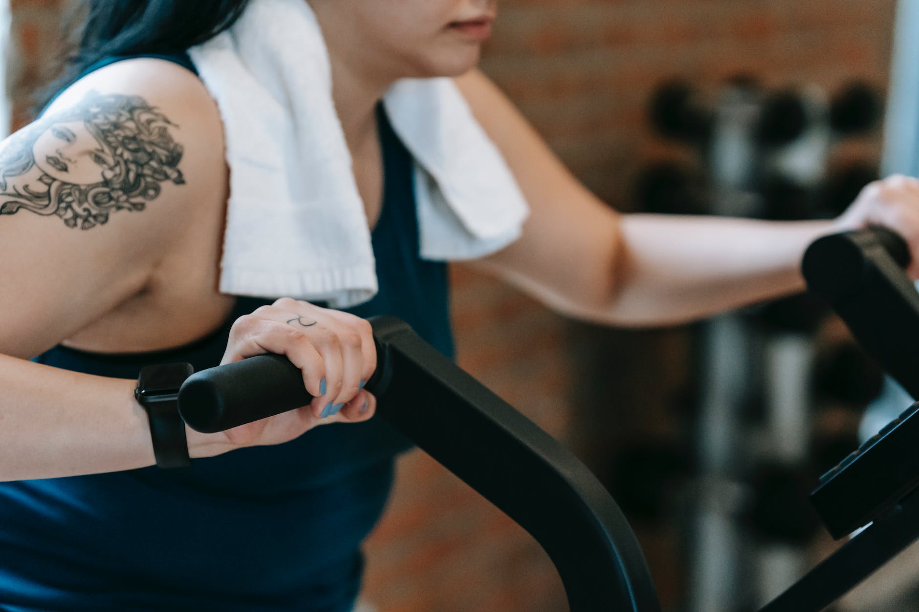 young woman doing exercises on cycling machine